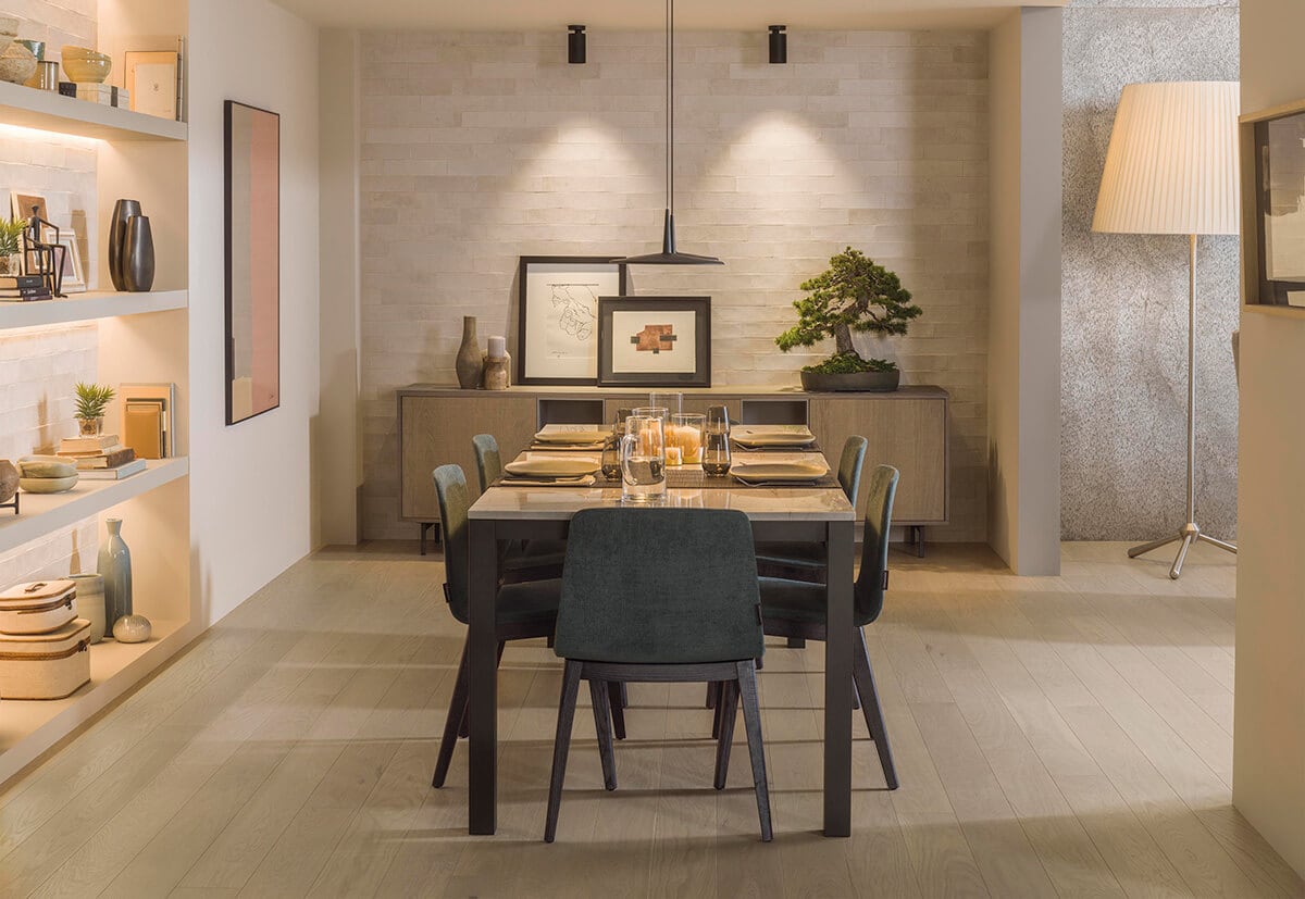 Dining room with wooden floor and limestone wall