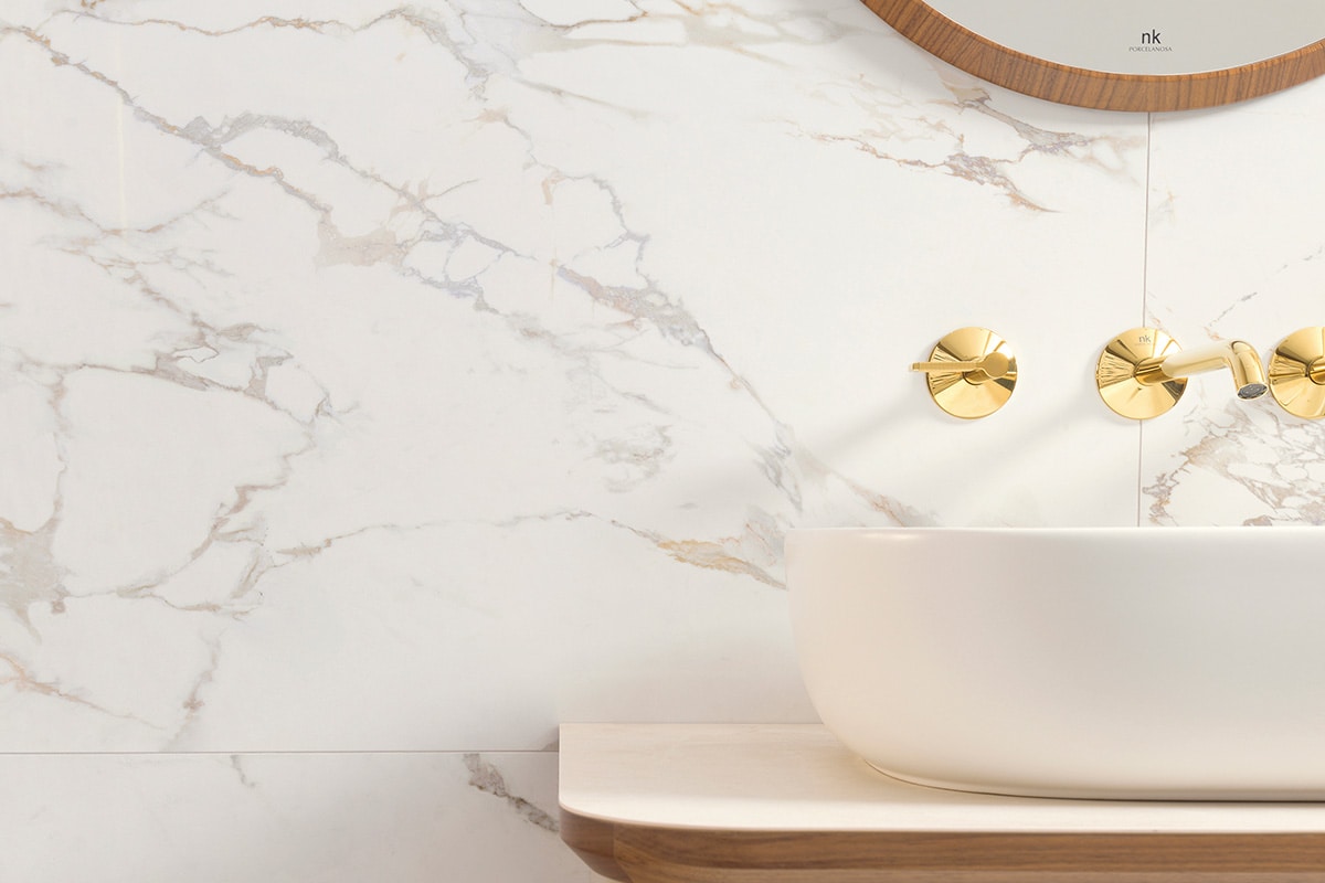 Large format marble effect tiles on a bathroom wall