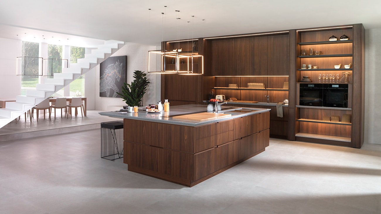 Island kitchen design, open to the living area. Featuring Newport Acero Nature floor tiles by Porcelanosa