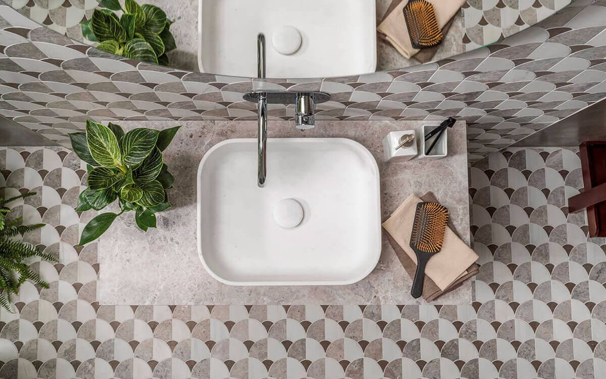 Patterned floor tiles creating a carpet effect zone in the living room