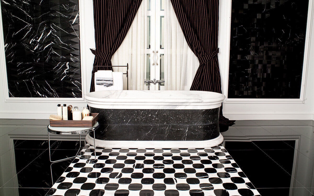 Bathroom with black and white mosaic floor tiles