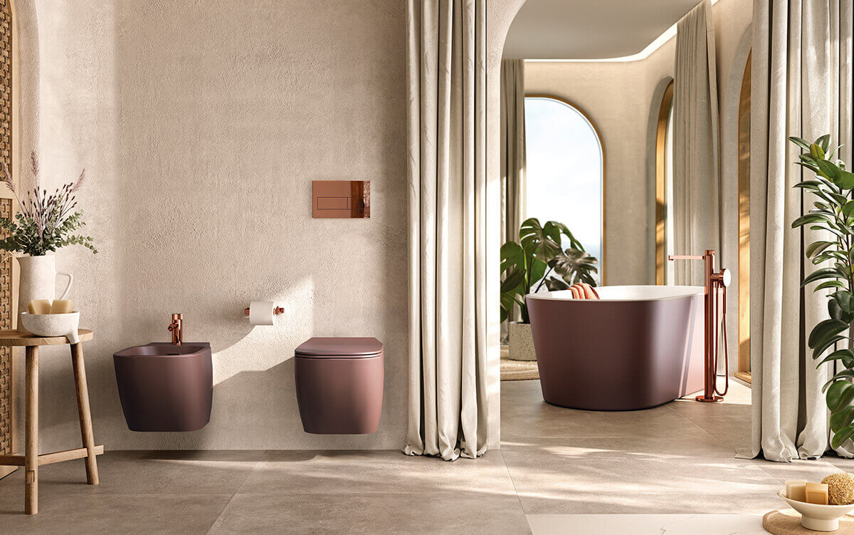 Bathroom with colourful sanitaryware and rose gold brassware by Porcelanosa